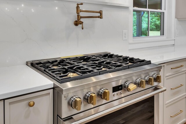 2513 Hillsboro Rd, Franklin, TN 37069 - kitchen view of stainless steel range, light countertops, pot filler, and white cabinets
