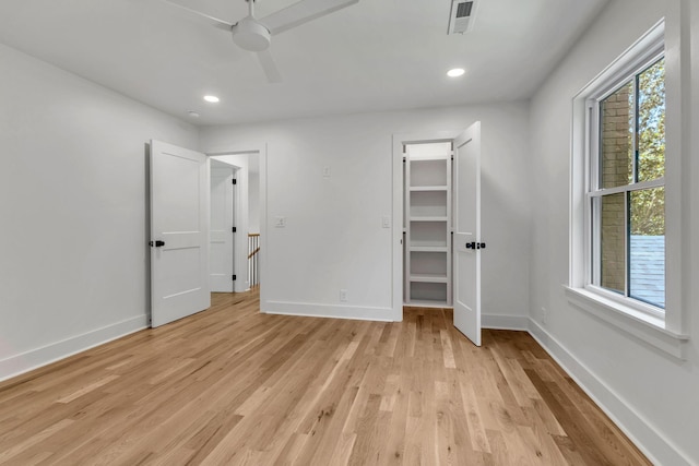 2513 Hillsboro Rd, Franklin, TN 37069 - unfurnished bedroom featuring light wood-style flooring, baseboards, recessed lighting, ceiling fan, and a walk in closet