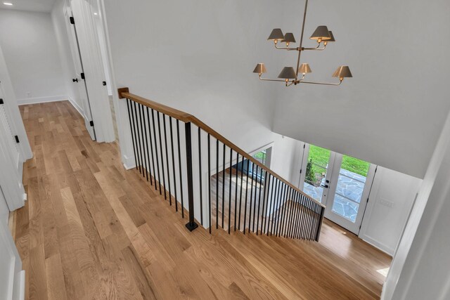 2513 Hillsboro Rd, Franklin, TN 37069 - stairway with wood finished floors, a chandelier, french doors, baseboards, and a towering ceiling