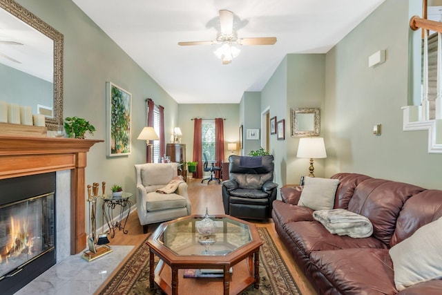 705 W Statue Ct, Franklin, TN 37067 - living area with a ceiling fan, a fireplace with flush hearth, stairway, and wood finished floors
