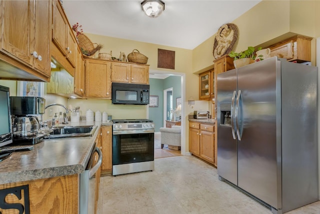705 W Statue Ct, Franklin, TN 37067 - kitchen featuring appliances with stainless steel finishes, a sink, and brown cabinets
