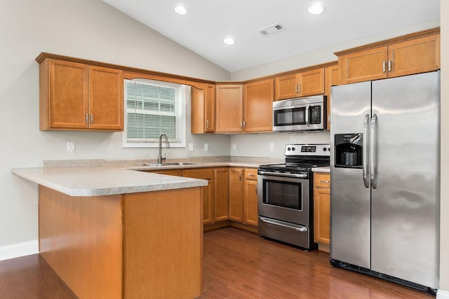 1643 Bobby Nichols Dr, Cookeville, TN 38506 - kitchen featuring stainless steel appliances, a sink, a peninsula, dark wood finished floors, and lofted ceiling