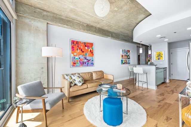 living area with light wood-type flooring, recessed lighting, and baseboards