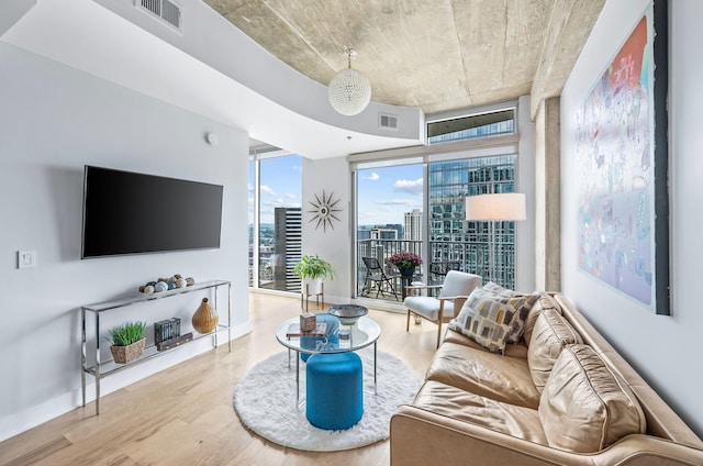living room with wood finished floors, expansive windows, and baseboards