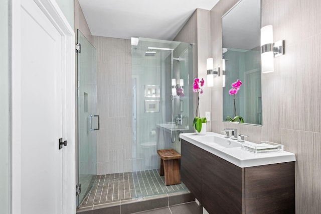 bathroom with a stall shower and vanity