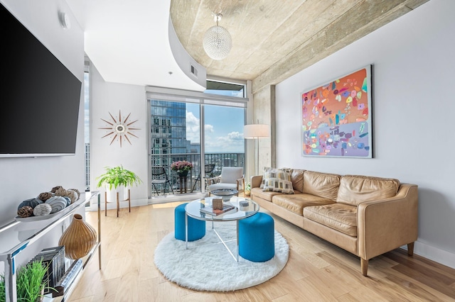 living area with expansive windows and wood finished floors