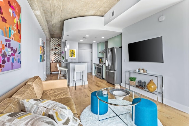 living area featuring light wood-style floors and recessed lighting