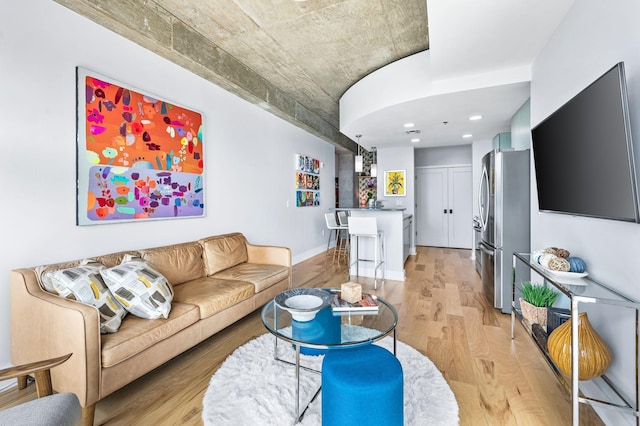 living area featuring light wood-style floors and recessed lighting