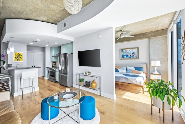living room featuring light wood-type flooring and ceiling fan
