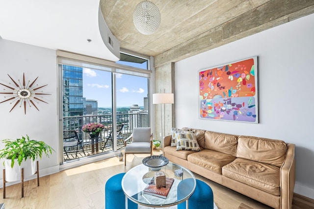 living area featuring a city view, wood finished floors, and a wall of windows