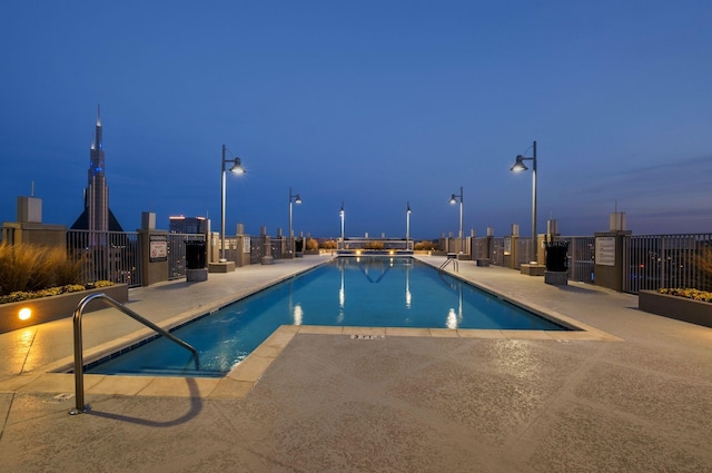 community pool featuring a patio area and fence