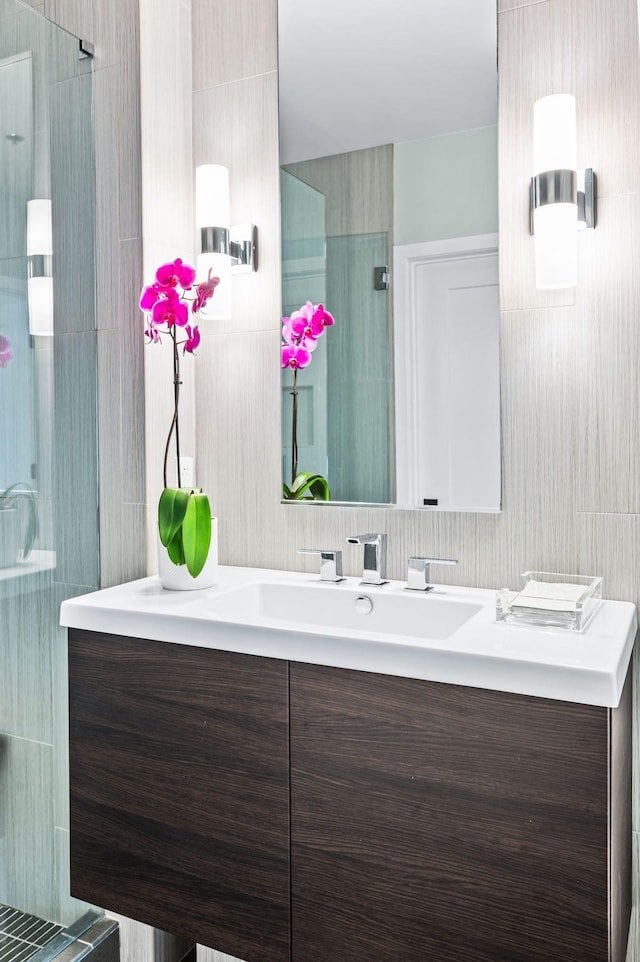 full bath with a shower stall and vanity