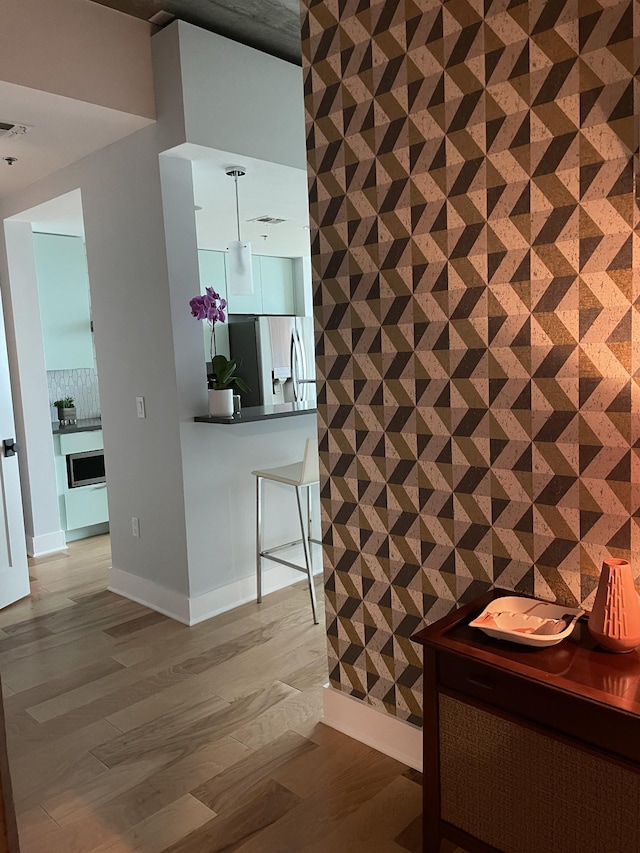 unfurnished dining area featuring wood finished floors and baseboards