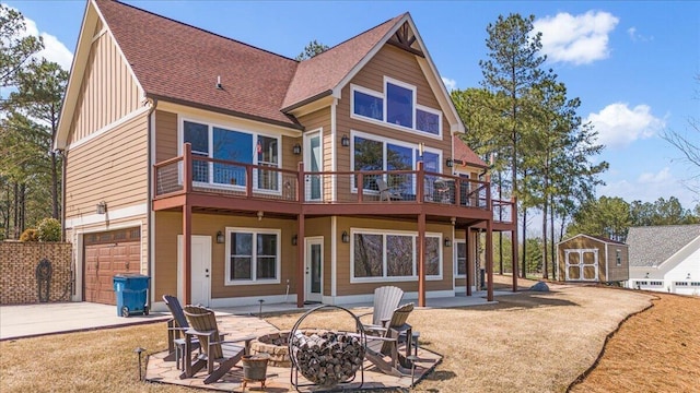 510 Lookout View Dr Unit Rb-177, Jasper, TN 37347 - rear view of house featuring a storage unit, an attached garage, a shingled roof, a fire pit, and an outdoor structure