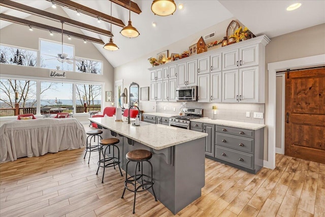 510 Lookout View Dr Unit Rb-177, Jasper, TN 37347 - kitchen featuring appliances with stainless steel finishes, gray cabinets, beam ceiling, light wood-style floors, and open floor plan