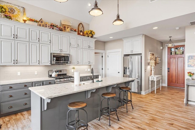 510 Lookout View Dr Unit Rb-177, Jasper, TN 37347 - kitchen with appliances with stainless steel finishes, tasteful backsplash, gray cabinets, light wood-style floors, and decorative light fixtures