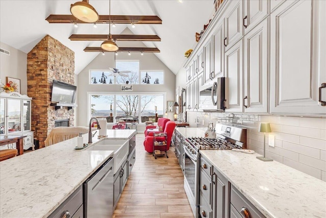 510 Lookout View Dr Unit Rb-177, Jasper, TN 37347 - kitchen featuring stainless steel appliances, open floor plan, ceiling fan, beam ceiling, and high vaulted ceiling