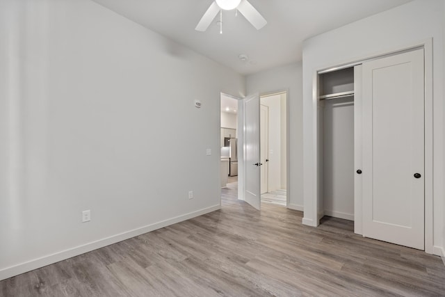unfurnished bedroom with light wood finished floors, baseboards, a closet, and ceiling fan