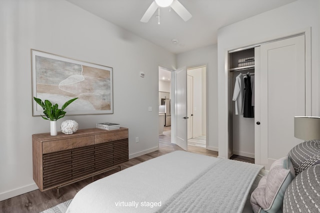 bedroom featuring wood finished floors, a closet, baseboards, and ceiling fan