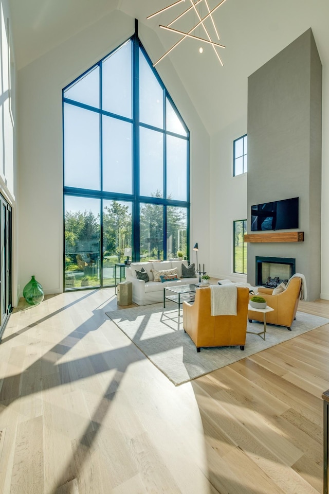 84 Judd Ln, Lancaster, TN 38569 - living area with high vaulted ceiling, a chandelier, a fireplace, and light wood-style flooring