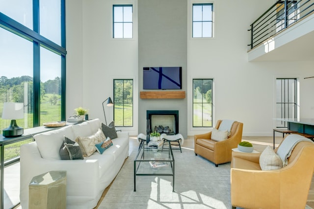 84 Judd Ln, Lancaster, TN 38569 - living area featuring a towering ceiling, a fireplace, plenty of natural light, and baseboards