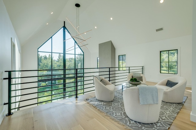 84 Judd Ln, Lancaster, TN 38569 - living room featuring high vaulted ceiling, healthy amount of natural light, wood finished floors, and baseboards