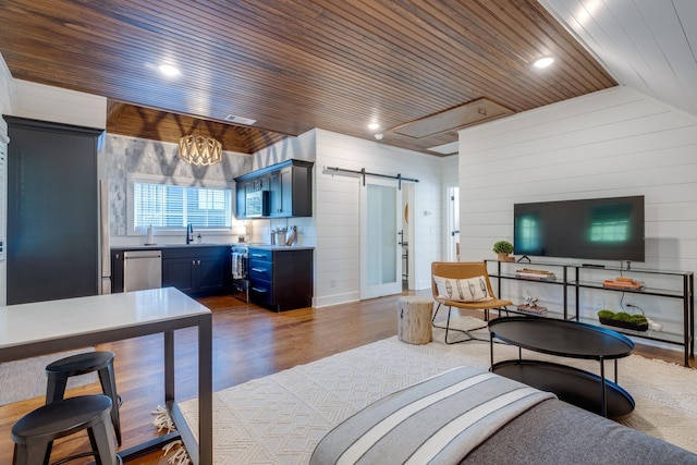 84 Judd Ln, Lancaster, TN 38569 - living room featuring a barn door, wooden ceiling, wood walls, wood finished floors, and vaulted ceiling