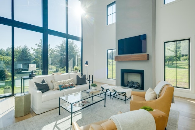 84 Judd Ln, Lancaster, TN 38569 - living room featuring a towering ceiling, wood finished floors, a fireplace, and baseboards