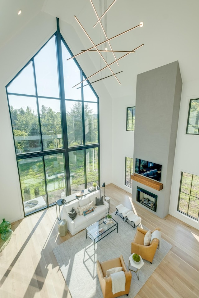 84 Judd Ln, Lancaster, TN 38569 - living room with high vaulted ceiling, plenty of natural light, wood finished floors, and a fireplace