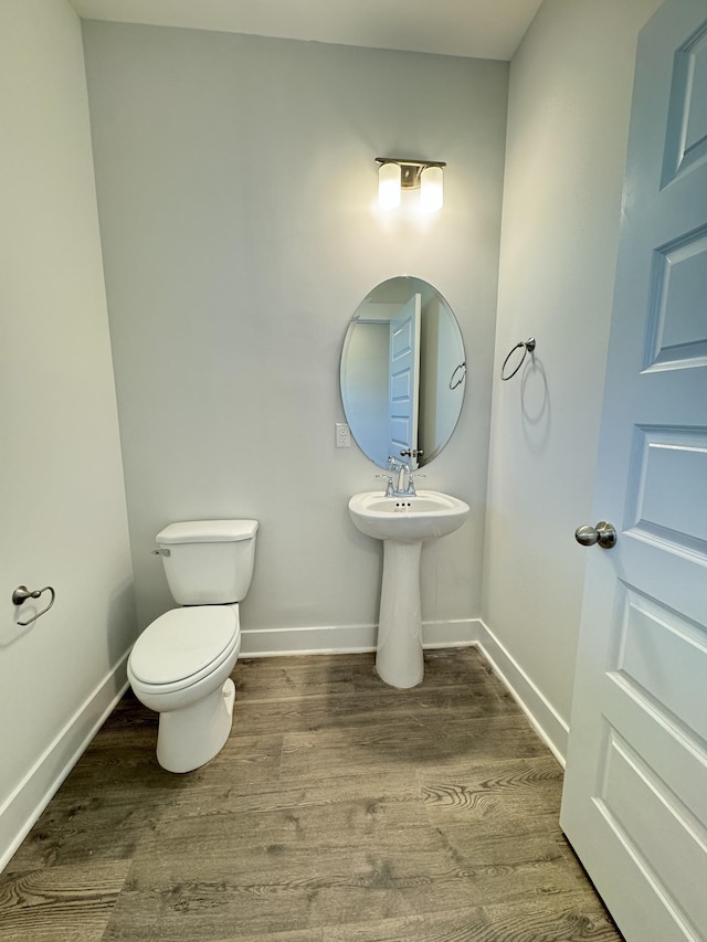 7639 Rookers Bend Dr, Smyrna, TN 37167 - half bathroom featuring wood finished floors, toilet, and baseboards