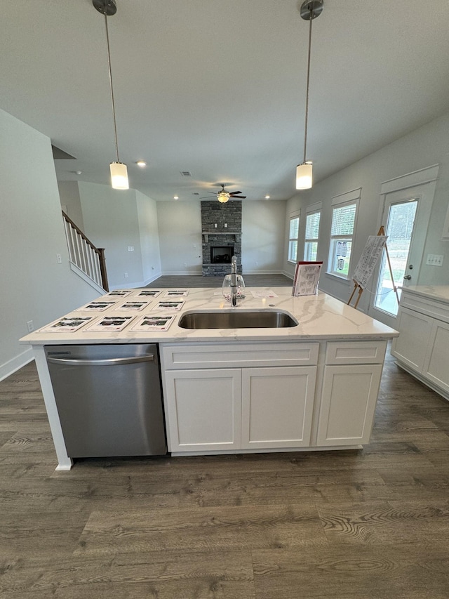 7639 Rookers Bend Dr, Smyrna, TN 37167 - kitchen featuring dishwasher, a sink, a large fireplace, open floor plan, and white cabinetry