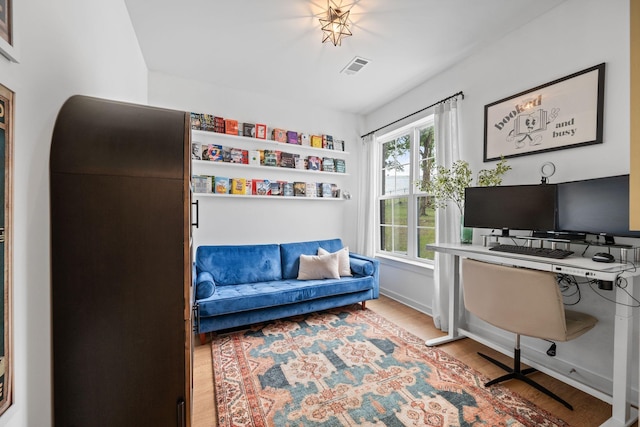 home office with wood finished floors and baseboards