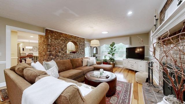 152 Bluegrass Dr, Hendersonville, TN 37075 - living room featuring a brick fireplace, light wood-style flooring, recessed lighting, and baseboards