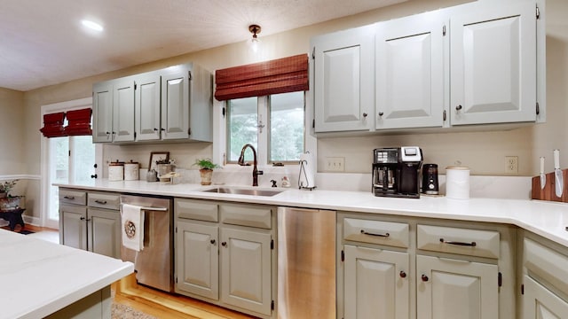 152 Bluegrass Dr, Hendersonville, TN 37075 - kitchen with stainless steel dishwasher, a sink, light countertops, and light wood-type flooring