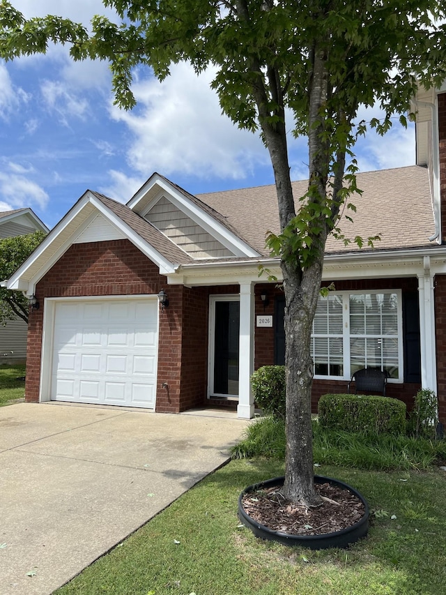 ranch-style house with brick siding, concrete driveway, an attached garage, and a shingled roof