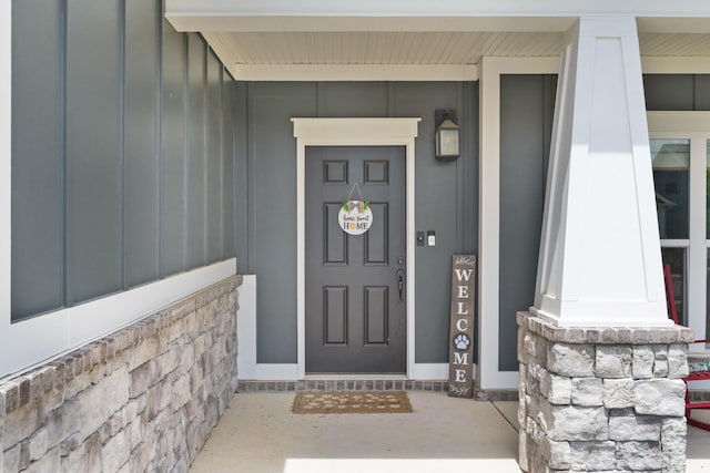 doorway to property featuring board and batten siding and a porch