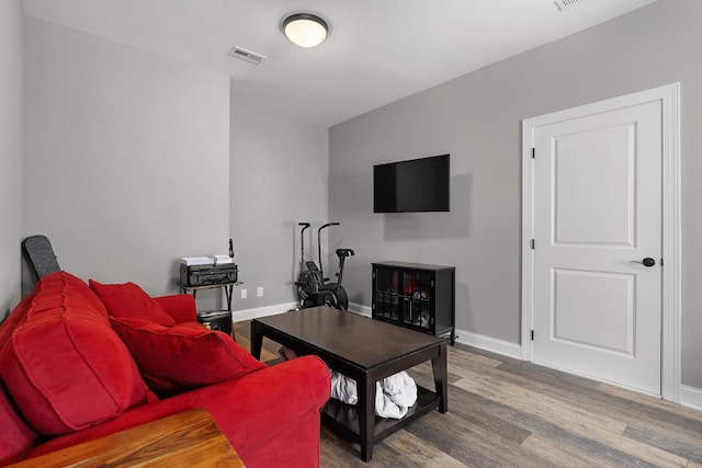 living area featuring wood finished floors and baseboards