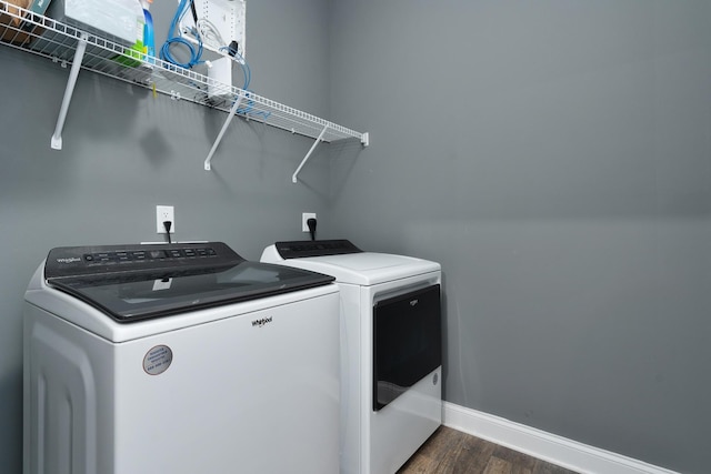 laundry room featuring separate washer and dryer, dark wood finished floors, and baseboards