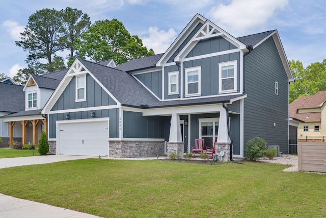 craftsman house featuring board and batten siding, covered porch, stone siding, and driveway