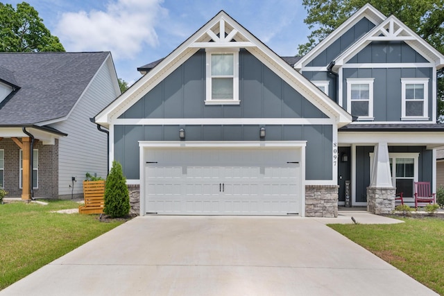 craftsman-style home featuring board and batten siding, stone siding, concrete driveway, and a front yard
