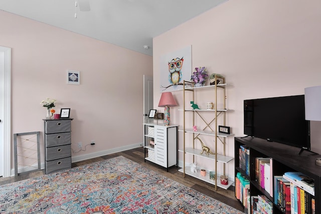 bedroom with wood finished floors and baseboards