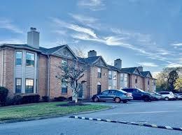 view of building exterior featuring uncovered parking