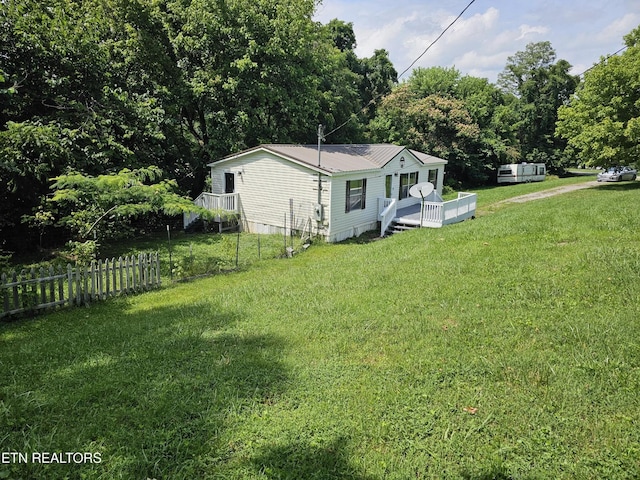 277 Coolidge Rd, La Follette, TN 37766 - view of home's exterior featuring a wooden deck and a metal roof