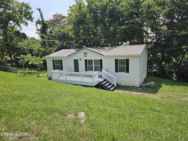 277 Coolidge Rd, La Follette, TN 37766 - manufactured / mobile home with a wooden deck, a front lawn, and a metal roof