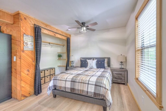 bedroom featuring wood finished floors, ceiling fan, and baseboards
