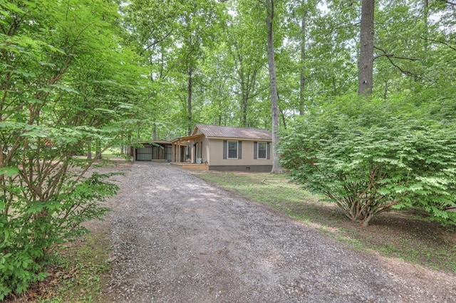 ranch-style house with gravel driveway, crawl space, and metal roof