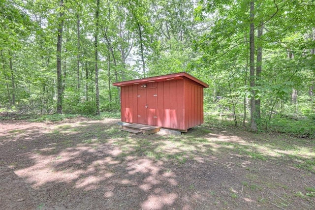 view of shed with a forest view