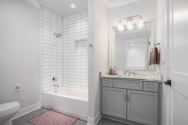 bathroom featuring toilet, tile patterned flooring, baseboards, vanity, and shower / bathtub combination