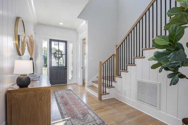 entrance foyer featuring wood finished floors, stairway, baseboards, and recessed lighting