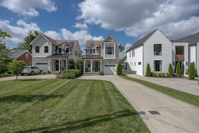 view of front of home with a standing seam roof, an attached garage, driveway, a front yard, and metal roof